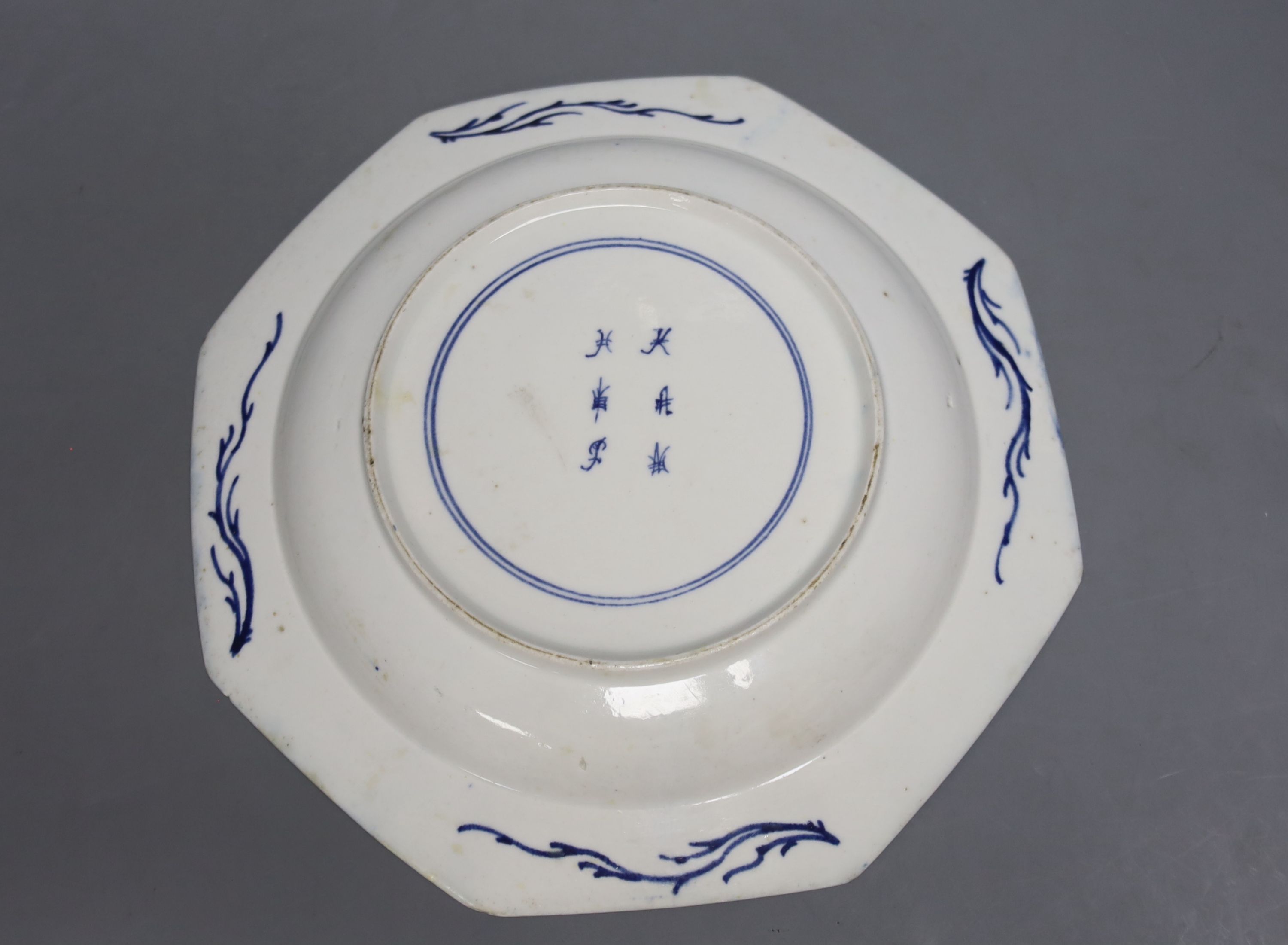 A Bow octagonal plate, painted with landscapes on a blue ground, c.1757, six character mark, 22cm across